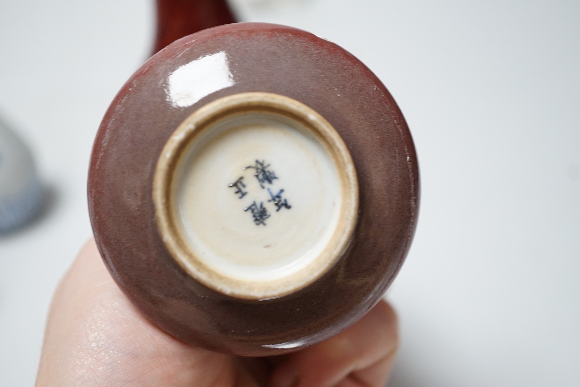 A Chinese sang de boeuf bottle neck vase, together with four Chinese miniature vases, three Chinese figures and a Chinese tea bowl, tallest 15cm